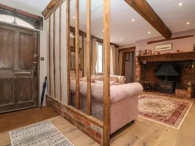a bedroom with a bed in a room with a fireplace at The Bridewell in Woodbridge
