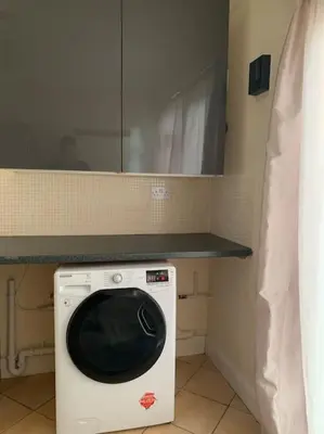 a washing machine in a kitchen with a counter at Super King Bed Suite, Executive office, fast WiFi, free parking in St Ives