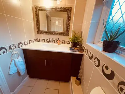 a bathroom with a sink and a mirror at Super King Bed Suite, Executive office, fast WiFi, free parking in St Ives
