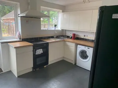 a kitchen with a washing machine and a washer at St Ives, King Bed Cosy home, parking, fast Wi Fi in St Ives