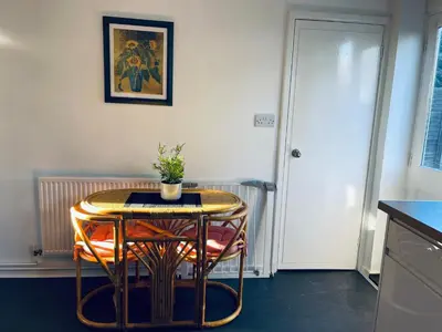 a table with a potted plant on top of it at St Ives, King Bed Cosy home, parking, fast Wi Fi in St Ives