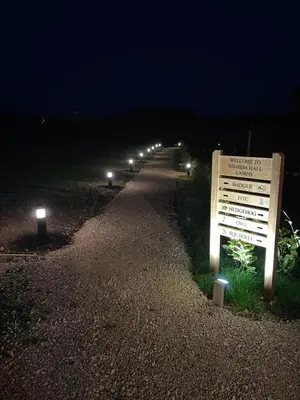 a row of lights on a road at night at Wimbish Hall Cabins in Wimbish