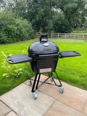 a bbq grill sitting on top of a patio at Wimbish Hall Cabins in Wimbish