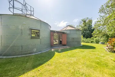 a cylindrical home with a cylindrical metal building at Extraordinarily converted grain stores - The Silos in Ipswich