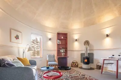 a living room with a couch and a fire place at Extraordinarily converted grain stores - The Silos in Ipswich