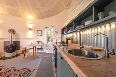 a kitchen with a large sink and a table at Extraordinarily converted grain stores - The Silos in Ipswich