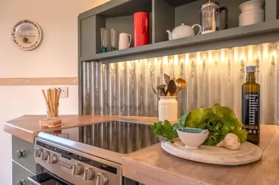 a kitchen with a counter with a bottle of wine at Extraordinarily converted grain stores - The Silos in Ipswich