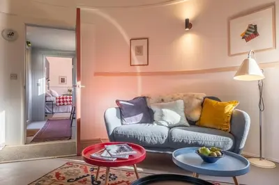 a living room with a couch and a table at Extraordinarily converted grain stores - The Silos in Ipswich