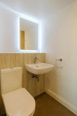 a bathroom with a white toilet and a sink at Admiral's Rest in Aldeburgh