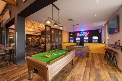 a billiard room with a pool table and a bar at VaLa VistA - Holiday Home On The Beach in Jaywick Sands