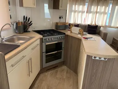 a small kitchen with a stove and a sink at VaLa VistA - Holiday Home On The Beach in Jaywick Sands