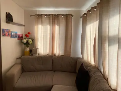 a living room with a couch and curtains at VaLa VistA - Holiday Home On The Beach in Jaywick Sands