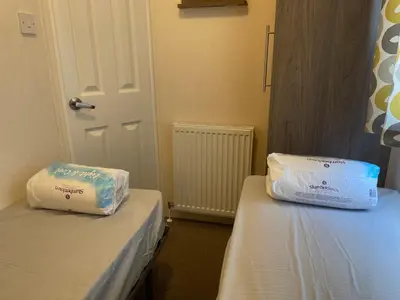 two beds sitting next to each other in a room at VaLa VistA - Holiday Home On The Beach in Jaywick Sands