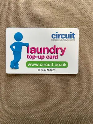 a sign for a laundry top up card at VaLa VistA - Holiday Home On The Beach in Jaywick Sands