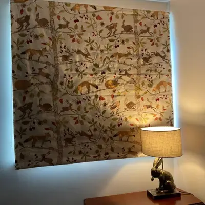 a painting of animals on a wall next to a lamp at Klara's House in West Mersea