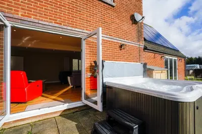 a bath tub in front of a brick building at Unique 5BD Farm House Perfect for Relaxing in Ipswich