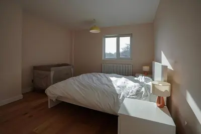 a small bedroom with a bed and a window at Unique 5BD Farm House Perfect for Relaxing in Ipswich