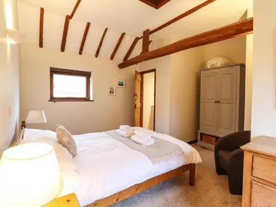 a bedroom with a large white bed in a room at The Granary in Colchester