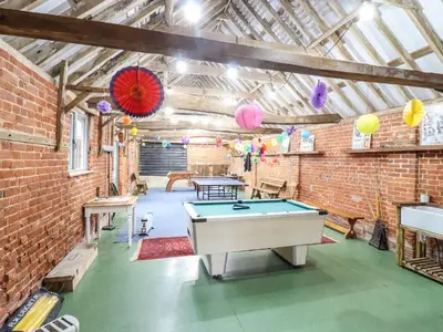 a ping pong room with a pool table in it at The Stables in Colchester