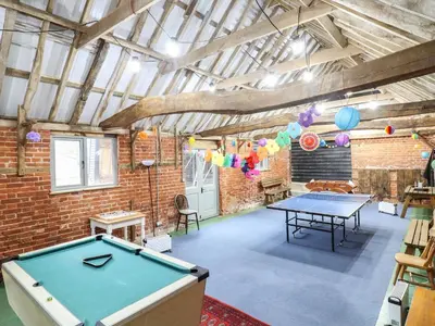 a ping pong table in a room with a ping pong ball at The Stables in Colchester