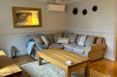 a living room with a couch and a coffee table at Cosy 2 bed, home from home in Haddenham