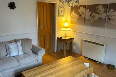 a living room with a couch and a table at Cosy 2 bed, home from home in Haddenham