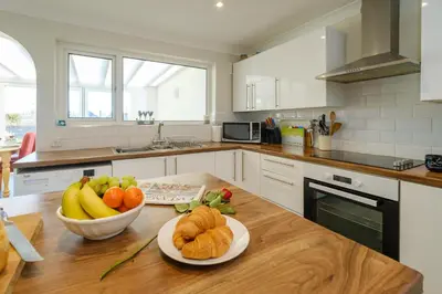 a kitchen with a bowl of fruit on a table at 61 Fairfield Road in Aldeburgh
