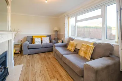 a living room with a couch and two couches at 61 Fairfield Road in Aldeburgh