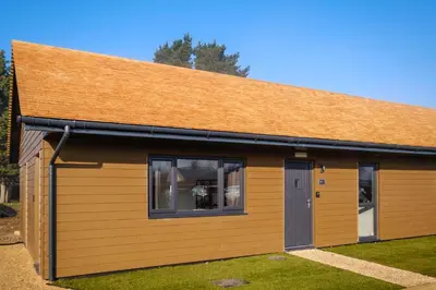 a brown building with a brown roof at Three Tuns - Garden Suite 1 in Wickham Market