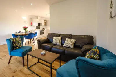 a living room with a couch and chairs and a table at Three Tuns - Garden Suite 2 in Wickham Market