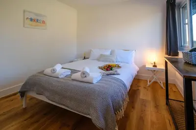 a bedroom with a bed with two towels on it at Three Tuns - Garden Suite 3 in Wickham Market