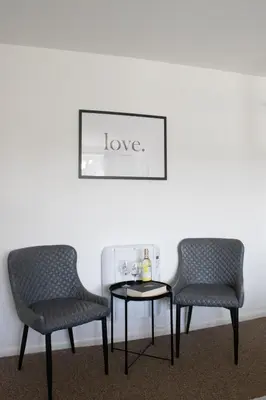 two chairs and a table in a room at The Live and Let Live in Downham Market