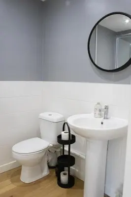 a bathroom with a white toilet and a sink at The Live and Let Live in Downham Market