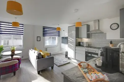 a kitchen and living room with a couch and a table at Towerview Apartments Braintree in Braintree