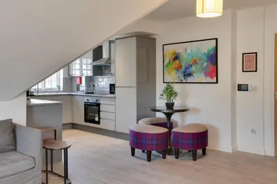a living room with a couch and a table withools at Towerview Apartments Braintree in Braintree
