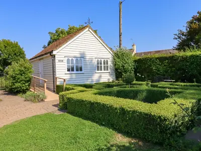 a garden with a house and a hedge at Rector's Retreat in Ipswich