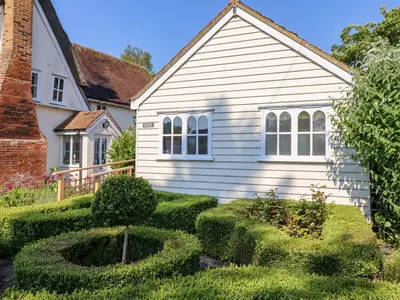 a house with a hedge in front of it at Rector's Retreat in Ipswich