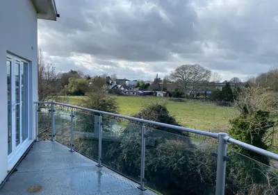 a balcony with a view of a field at Contemporary, Cosy & Homely 2 Bed Apartment with High-Speed WIFI, Terrace & Free Parking overlooking Stourbridge Common Park & Coldham's Brook in Cambridge