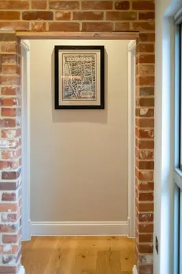 a room with a brick wall and a picture on the wall at Alde Bay Farm - Oyster Catcher in Aldeburgh