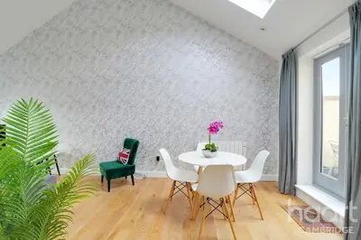 a dining room with a white table and chairs at Lovely 1 Bedroom Flat with Free Off Road Parking in Chesterton