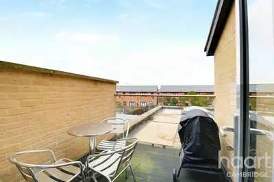 a patio with chairs and a table on a deck at Lovely 1 Bedroom Flat with Free Off Road Parking in Chesterton