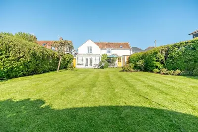 a large lawn in front of a house at 4 Bed in Aldeburgh oc-al123 in Aldeburgh