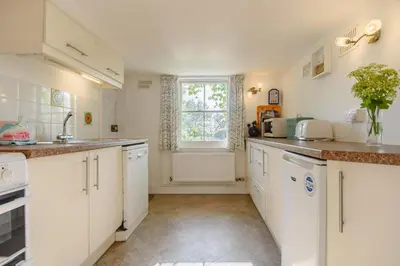 a kitchen with white cabinets and a window at 4 Bed in Aldeburgh oc-al123 in Aldeburgh