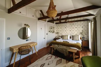 a bedroom with a bed and a table in a room at Pembroke in Aldeburgh