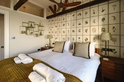 a bedroom with a bed with towels on it at Pembroke in Aldeburgh