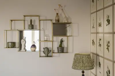 a room with shelves with vases and a stool at Pembroke in Aldeburgh