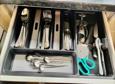 a tray filled with utensils in a sink at Kiwi Tree Serviced Apartment in Cambridge