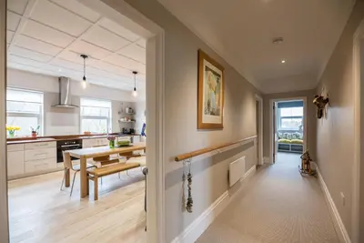 a kitchen with a table and a dining room at 3 St Nicholas Court, Aldeburgh in Aldeburgh