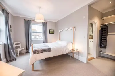 a bedroom with a bed and a large window at 3 St Nicholas Court, Aldeburgh in Aldeburgh