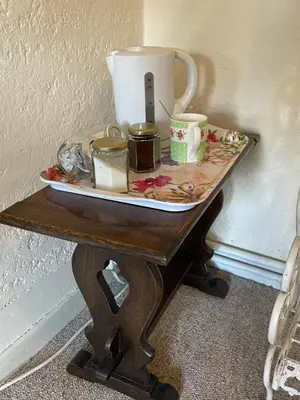 a table with a tea pot and candles on it at The Bridge Street Historic Guest House in Sudbury